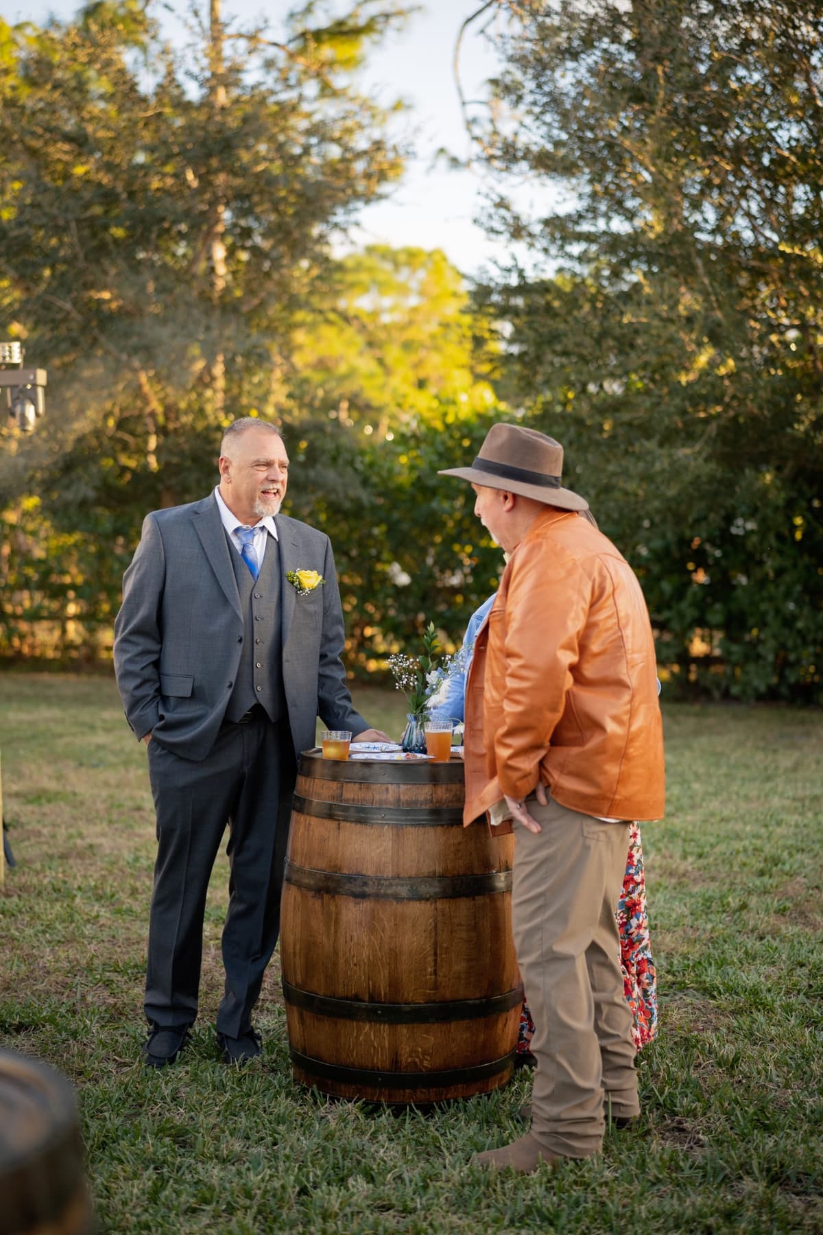 Wedding guests around a whiskey barrel